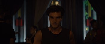 Movie still from “Hellraiser” (2022), directed by David Bruckner – A young man is standing in a dark room; Close Up shot, Over the shoulder angle