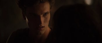 Movie still from “Hellraiser” (2022), directed by David Bruckner – A man's face in the dark; Close Up shot, Over the shoulder angle