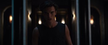 Movie still from “Hellraiser” (2022), directed by David Bruckner – A man in a black tank top standing in a dark room; Close Up shot, Low angle