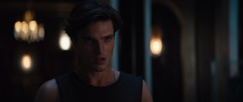 Movie still from “Hellraiser” (2022), directed by David Bruckner – A person wearing a black shirt; Close Up shot, Over the shoulder angle