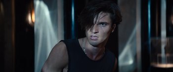 Movie still from “Hellraiser” (2022), directed by David Bruckner – A man with long black hair wearing a black tank top; Close Up shot, Low angle