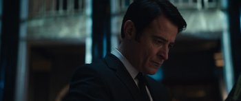 Movie still from “Hellraiser” (2022), directed by David Bruckner – A person wearing a suit and tie; Close Up shot, Over the shoulder angle