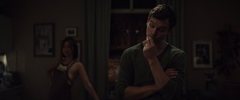 Movie still from “Hellraiser” (2022), directed by David Bruckner – A man and a woman in a dark room; Medium shot, Over the shoulder angle