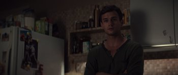 Movie still from “Hellraiser” (2022), directed by David Bruckner – A man standing in a room with his arms crossed; Medium shot, Over the shoulder angle