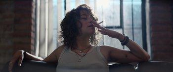 Movie still from “Hellraiser” (2022), directed by David Bruckner – A woman is smoking a cigarette while a woman is holding her hand to her mouth; Close Up shot, Low angle