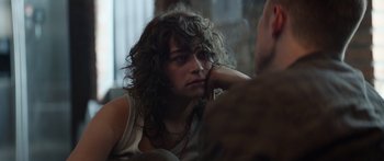 Movie still from “Hellraiser” (2022), directed by David Bruckner – A person with curly hair sitting in front of a mirror; Close Up shot, Over the shoulder angle