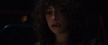 Movie still from “Hellraiser” (2022), directed by David Bruckner – A person with curly hair; Close Up shot, Low angle