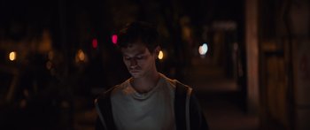 Movie still from “Hellraiser” (2022), directed by David Bruckner – A young man standing on a street at night with his eyes wide open; Close Up shot, Low angle