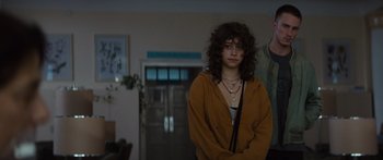 Movie still from “Hellraiser” (2022), directed by David Bruckner – A young woman standing next to a man in front of a building; Medium shot, Over the shoulder angle