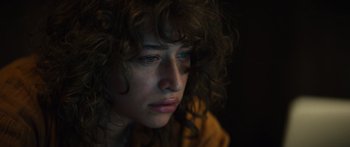 Movie still from “Hellraiser” (2022), directed by David Bruckner – A person with curly brown hair; Close Up shot, High angle