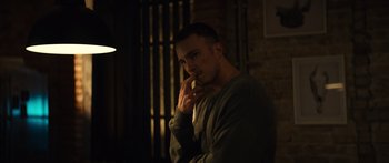 Movie still from “Hellraiser” (2022), directed by David Bruckner – A man standing in the dark holding a cell phone to his ear; Close Up shot, Low angle