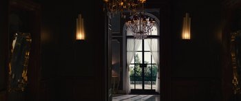 Movie still from “Hellraiser” (2022), directed by David Bruckner – A view of a room through an arched window; Extreme Wide shot, Low angle