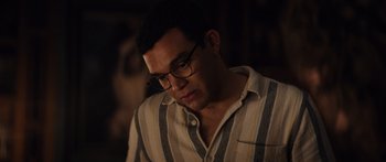 Movie still from “Hellraiser” (2022), directed by David Bruckner – A person wearing glasses; Close Up shot, Over the shoulder angle