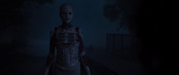 Movie still from “Hellraiser” (2022), directed by David Bruckner – A man with a face like a head like a human; Medium shot, Low angle