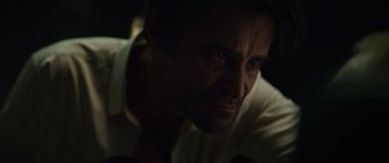 Movie still from “Hellraiser” (2022), directed by David Bruckner – A person with a beard looking at the camera; Close Up shot, Over the shoulder angle