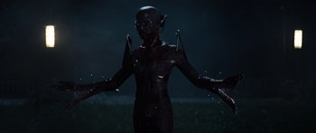Movie still from “Hellraiser” (2022), directed by David Bruckner – A woman in a black outfit standing in a field; Medium shot, Low angle