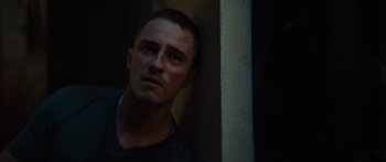 Movie still from “Hellraiser” (2022), directed by David Bruckner – A man with a bruised face leaning up against a wall; Close Up shot, Low angle