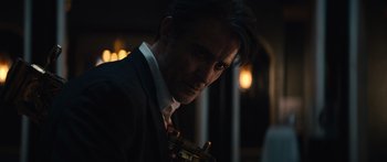 Movie still from “Hellraiser” (2022), directed by David Bruckner – A person wearing a suit and tie; Close Up shot, Low angle