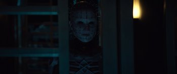 Movie still from “Hellraiser” (2022), directed by David Bruckner – A man with a face covered in many wires; Close Up shot, Low angle