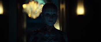 Movie still from “Hellraiser” (2022), directed by David Bruckner – A person with a face made out of pins; Close Up shot, Low angle