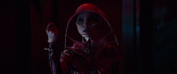 Movie still from “Hellraiser” (2022), directed by David Bruckner – A woman in a red outfit and a red hat; Close Up shot, Low angle