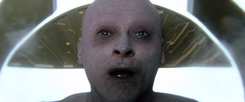 Movie still from “Hellraiser” (2022), directed by David Bruckner – A man with a bald head is looking into the camera; Extreme Close Up shot, Overhead angle