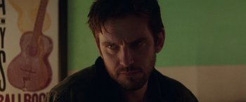 Movie still from “Her Smell” (2018), directed by Alex Ross Perry – A person staring at the camera; Close Up shot, Over the shoulder angle