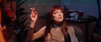 Movie still from “Her Smell” (2018), directed by Alex Ross Perry – A woman with long hair is smoking a cigarette; Close Up shot, Over the shoulder angle
