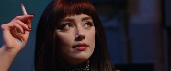 Movie still from “Her Smell” (2018), directed by Alex Ross Perry – A person with long red hair; Close Up shot, Over the shoulder angle