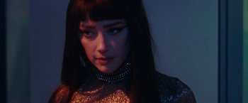 Movie still from “Her Smell” (2018), directed by Alex Ross Perry – A person with long black hair; Close Up shot, Low angle