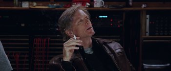 Movie still from “Her Smell” (2018), directed by Alex Ross Perry – A man smoking a cigarette while wearing a leather jacket; Close Up shot, Over the shoulder angle