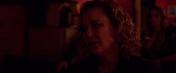 Movie still from “Her Smell” (2018), directed by Alex Ross Perry – A person in a dark room; Close Up shot, Over the shoulder angle