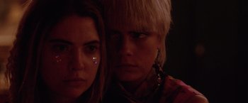 Movie still from “Her Smell” (2018), directed by Alex Ross Perry – Two women are looking at the camera with one of the women wearing earrings; Close Up shot, Over the shoulder angle