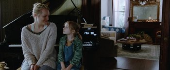 Movie still from “Her Smell” (2018), directed by Alex Ross Perry – A young girl sitting in front of a grand piano; Medium shot, Over the shoulder angle