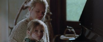Movie still from “Her Smell” (2018), directed by Alex Ross Perry – A woman and a child are looking at the camera; Close Up shot, Over the shoulder angle