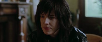 Movie still from “Her Smell” (2018), directed by Alex Ross Perry – A person wearing a black jacket; Close Up shot, Over the shoulder angle