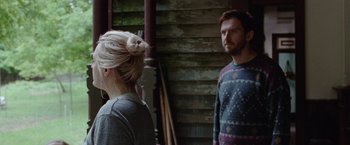 Movie still from “Her Smell” (2018), directed by Alex Ross Perry – A man and a woman standing next to each other in front of a building; Medium shot, Over the shoulder angle