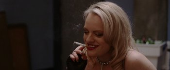 Movie still from “Her Smell” (2018), directed by Alex Ross Perry – A beautiful woman smoking a cigarette while holding a cell phone in her hand; Close Up shot, Over the shoulder angle