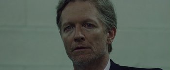 Movie still from “Her Smell” (2018), directed by Alex Ross Perry – A person wearing a suit and tie; Close Up shot, Low angle