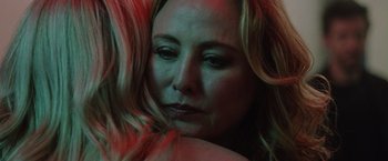 Movie still from “Her Smell” (2018), directed by Alex Ross Perry – A woman's face with pink hair; Close Up shot, Over the shoulder angle