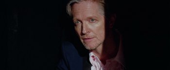 Movie still from “Her Smell” (2018), directed by Alex Ross Perry – A person wearing a suit and tie; Close Up shot, Low angle