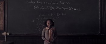 Movie still from “Hidden Figures” (2016), directed by Theodore Melfi – A girl standing in front of a chalkboard with equations written on it; Medium shot, Over the shoulder angle