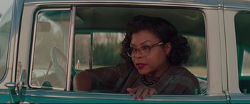 Movie still from “Hidden Figures” (2016), directed by Theodore Melfi – A woman sitting in the passenger seat of a green car; Medium shot, Over the shoulder angle