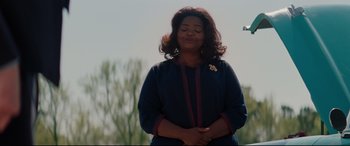 Movie still from “Hidden Figures” (2016), directed by Theodore Melfi – A woman standing in the sunlight with her eyes closed; Medium shot, Over the shoulder angle