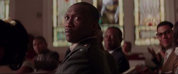 Movie still from “Hidden Figures” (2016), directed by Theodore Melfi – A man in a military uniform standing next to another man in a suit; Close Up shot, Low angle