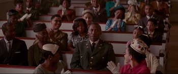 Movie still from “Hidden Figures” (2016), directed by Theodore Melfi – A group of people sitting in a row of seats; Medium shot, High angle