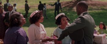 Movie still from “Hidden Figures” (2016), directed by Theodore Melfi – A couple of women sitting next to each other on a field; Medium shot, Over the shoulder angle