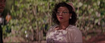 Movie still from “Hidden Figures” (2016), directed by Theodore Melfi – A woman in a pink dress and a pink bow; Close Up shot, Over the shoulder angle