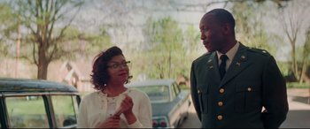 Movie still from “Hidden Figures” (2016), directed by Theodore Melfi – A man and a woman standing next to each other on the street; Medium shot, Over the shoulder angle