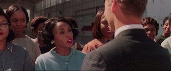 Movie still from “Hidden Figures” (2016), directed by Theodore Melfi – A group of people that are standing around each other; Close Up shot, Over the shoulder angle